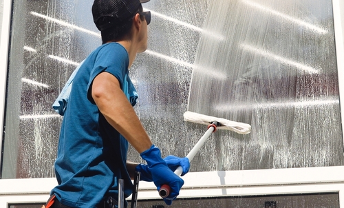 Male,Professional,Cleaning,Service,Worker,In,Overalls,Cleans,The,Windows janitorial services